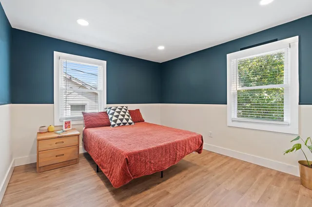 a bedroom with a bed and a window