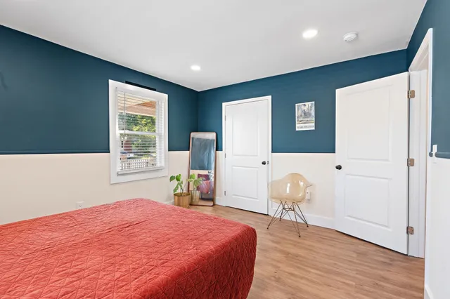 a bedroom with a bed and a chair