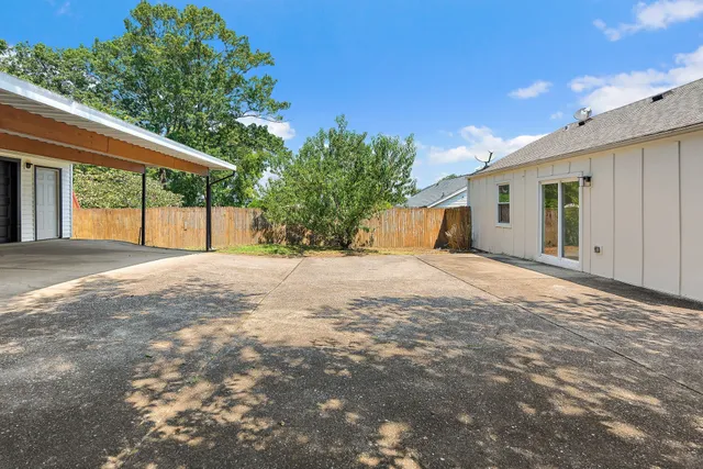 a view of a house with a yard and tree