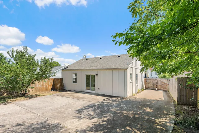 a view of a house with a yard and tree