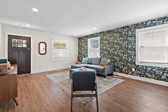 a living room with furniture and wooden floor