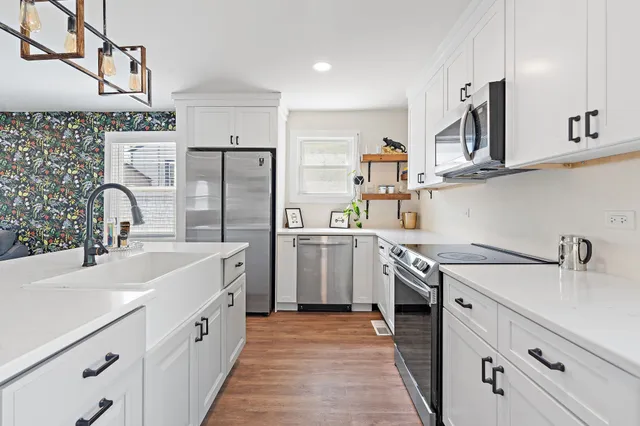 a kitchen with a sink stove and refrigerator