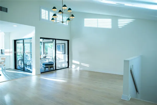 a living room with furniture and floor to ceiling windows