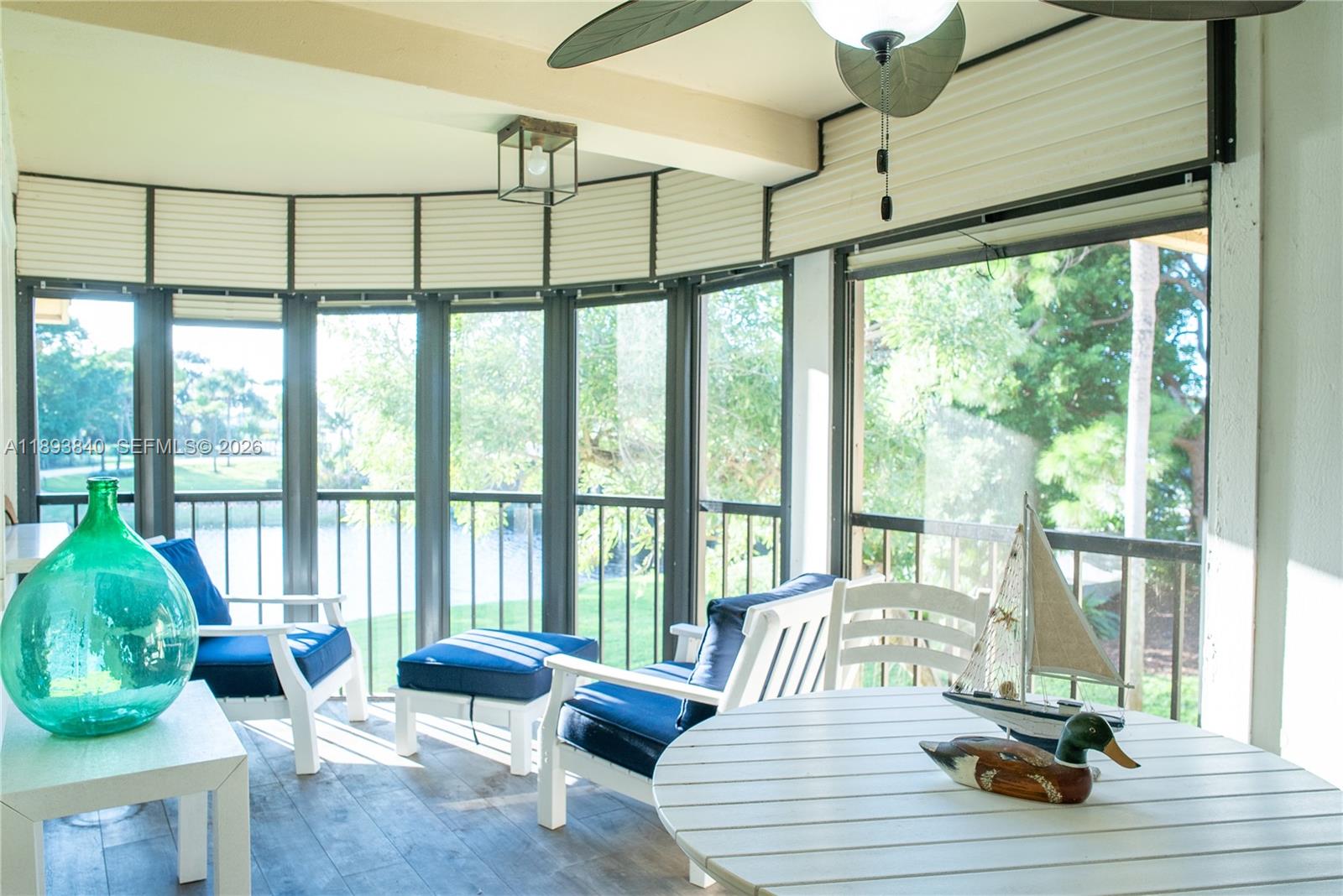 17081 Waterbend Drive, Unit 227 Jupiter, FL 33477 - Photo 12 of 38 a living room with furniture and floor to ceiling windows