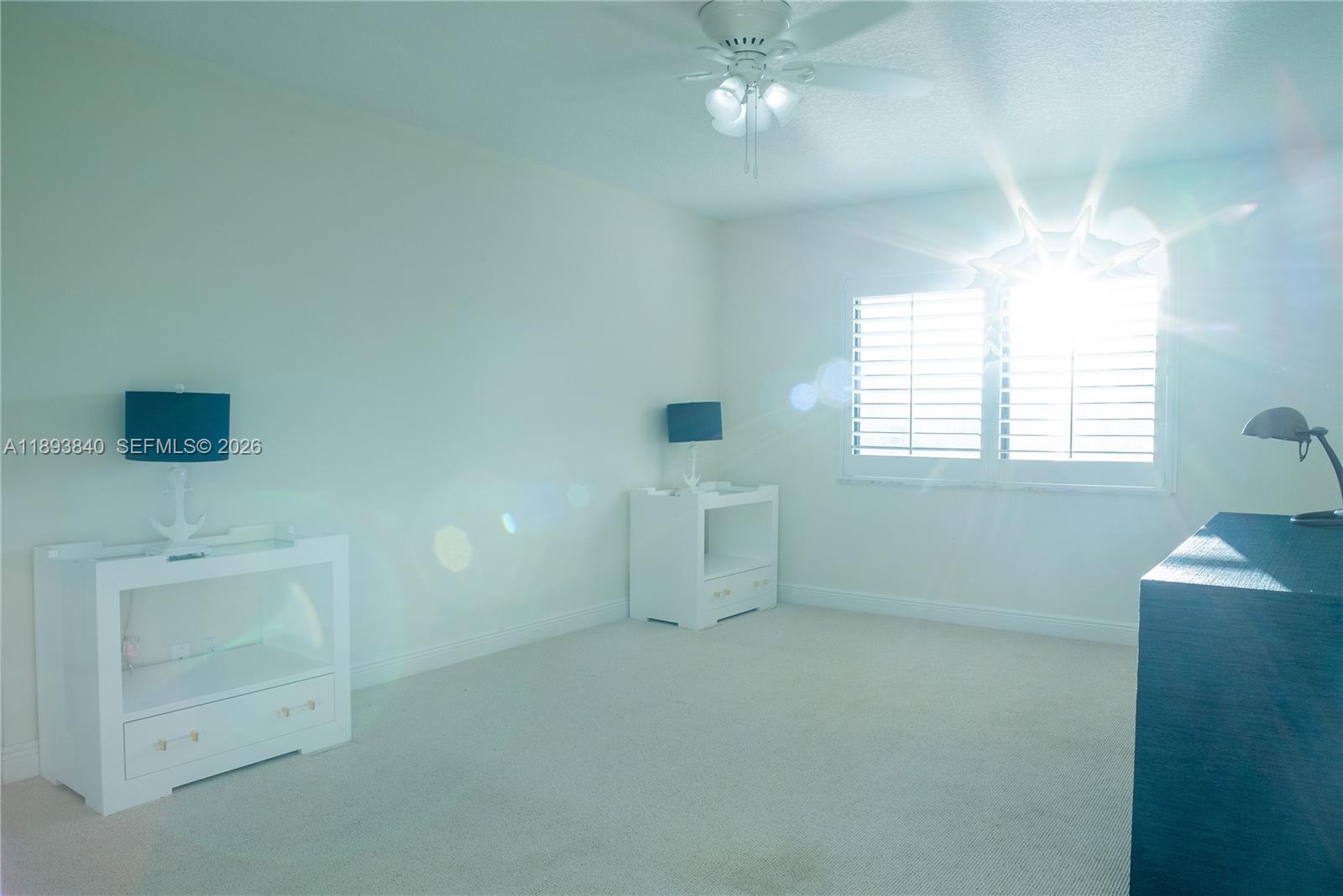 17081 Waterbend Drive, Unit 227 Jupiter, FL 33477 - Photo 17 of 38 en empty room with windows and chandelier fan