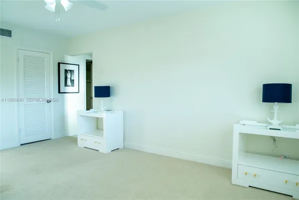 an empty room with a mirror and a window