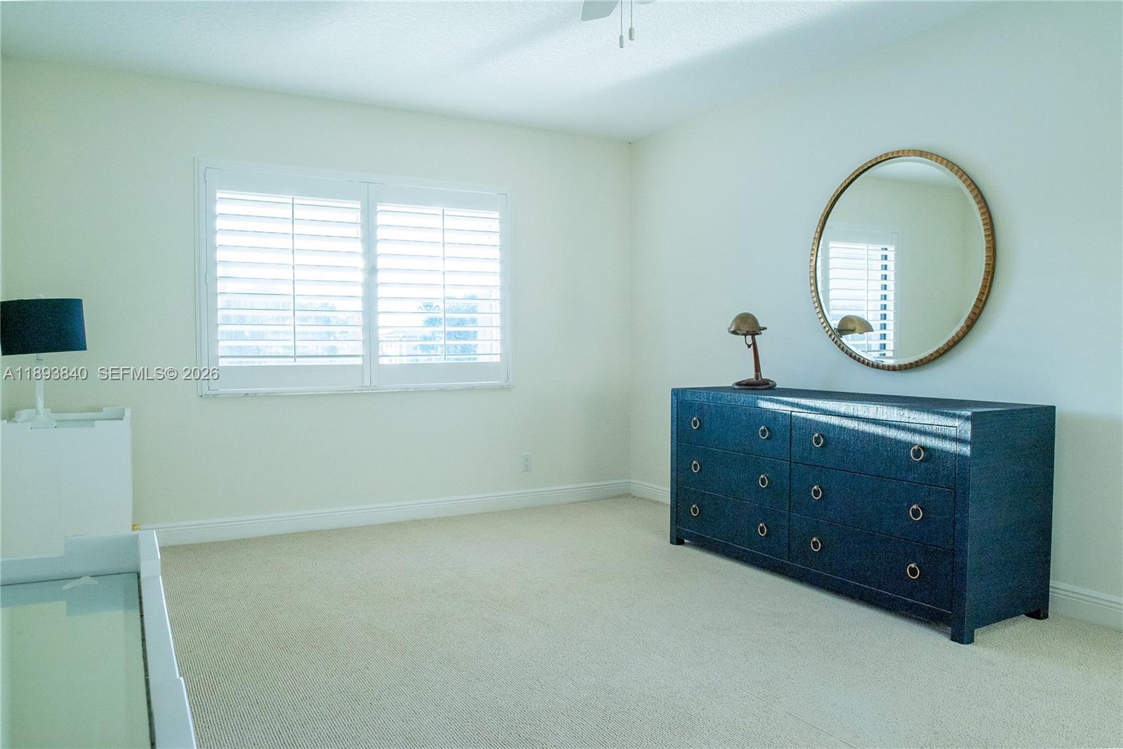 17081 Waterbend Drive, Unit 227 Jupiter, FL 33477 - Photo 19 of 38 an empty room with a mirror and a window