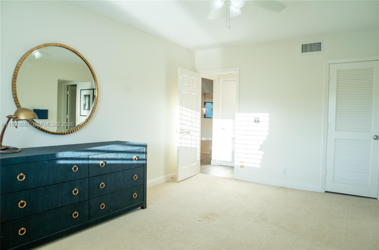 17081 Waterbend Drive, Unit 227 Jupiter, FL 33477 - Photo 20 of 38 a view of a mirror and a sink in a room