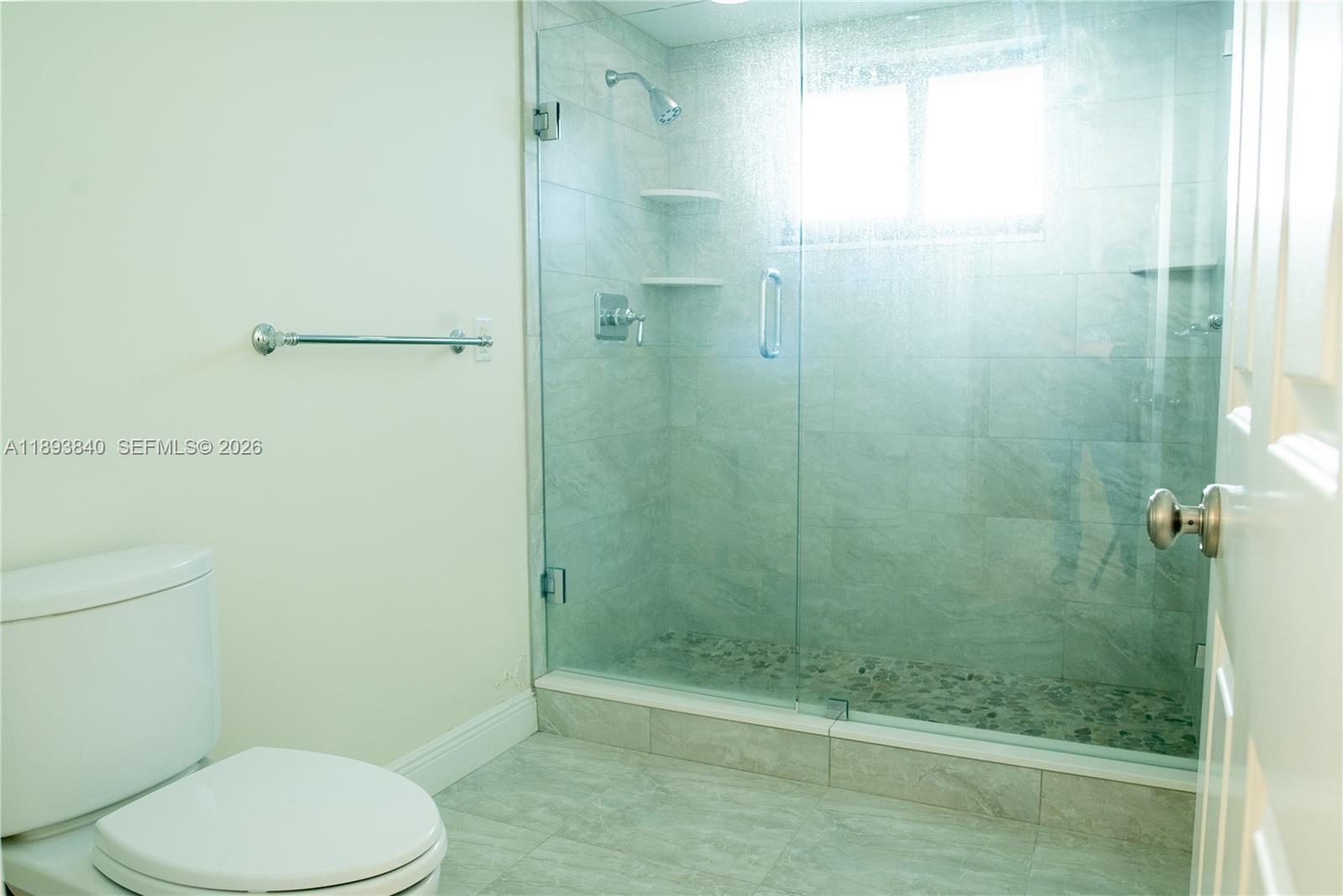 17081 Waterbend Drive, Unit 227 Jupiter, FL 33477 - Photo 22 of 38 a bathroom with a toilet and a shower