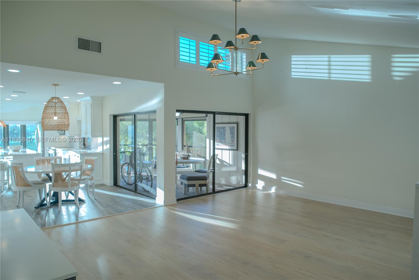 17081 Waterbend Drive, Unit 227 Jupiter, FL 33477 - Photo 24 of 38 a view of a room with chandelier potted plants and wooden floor