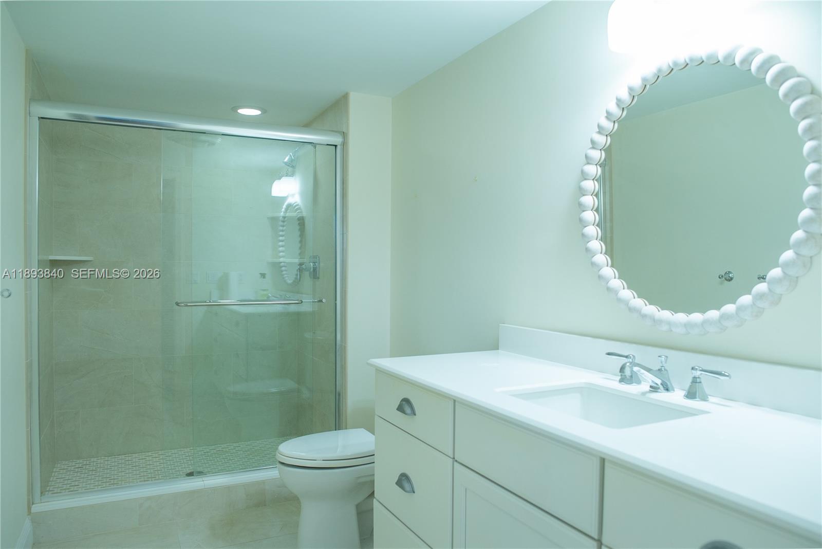 17081 Waterbend Drive, Unit 227 Jupiter, FL 33477 - Photo 28 of 38 a bathroom with a sink and a mirror