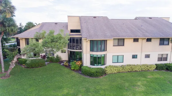 an aerial view of a house with swimming pool and big yard