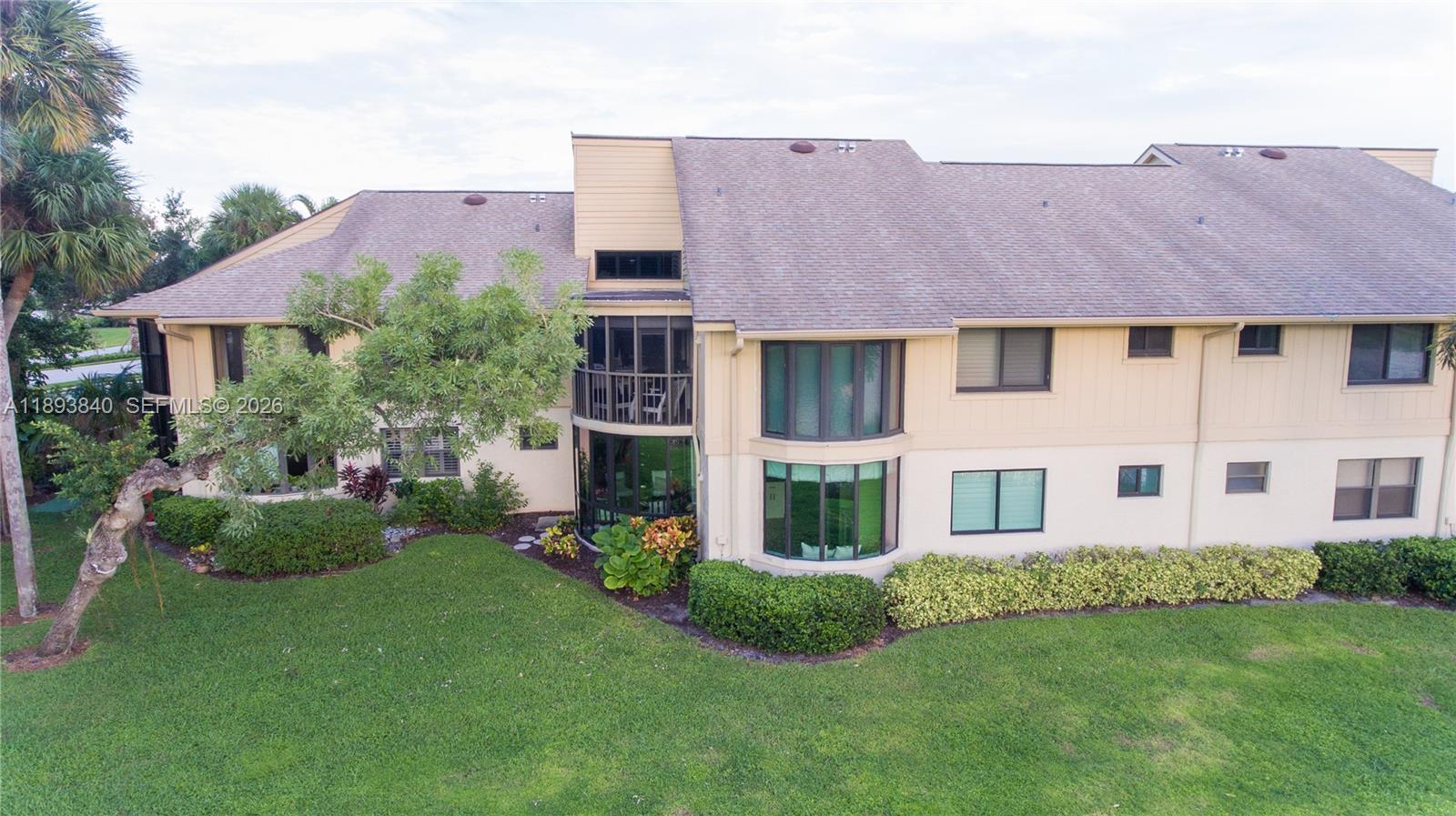 17081 Waterbend Drive, Unit 227 Jupiter, FL 33477 - Photo 37 of 38 a view of a house with a yard and plants