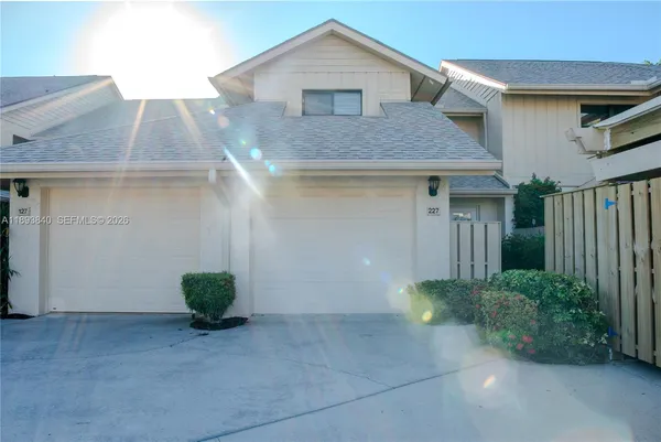 a kitchen with a table chairs sink and cabinets