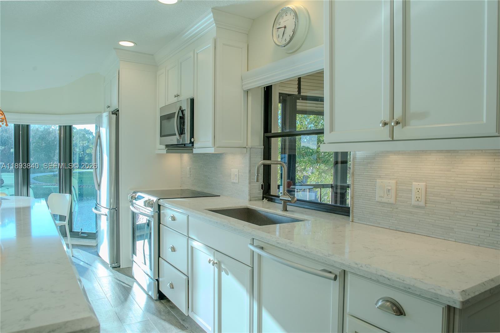 17081 Waterbend Drive, Unit 227 Jupiter, FL 33477 - Photo 7 of 38 a kitchen with a sink and cabinets