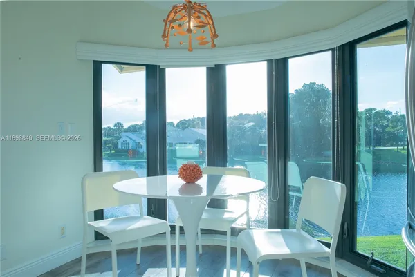 a view of dining room and livingroom with furniture wooden floor a chandelier