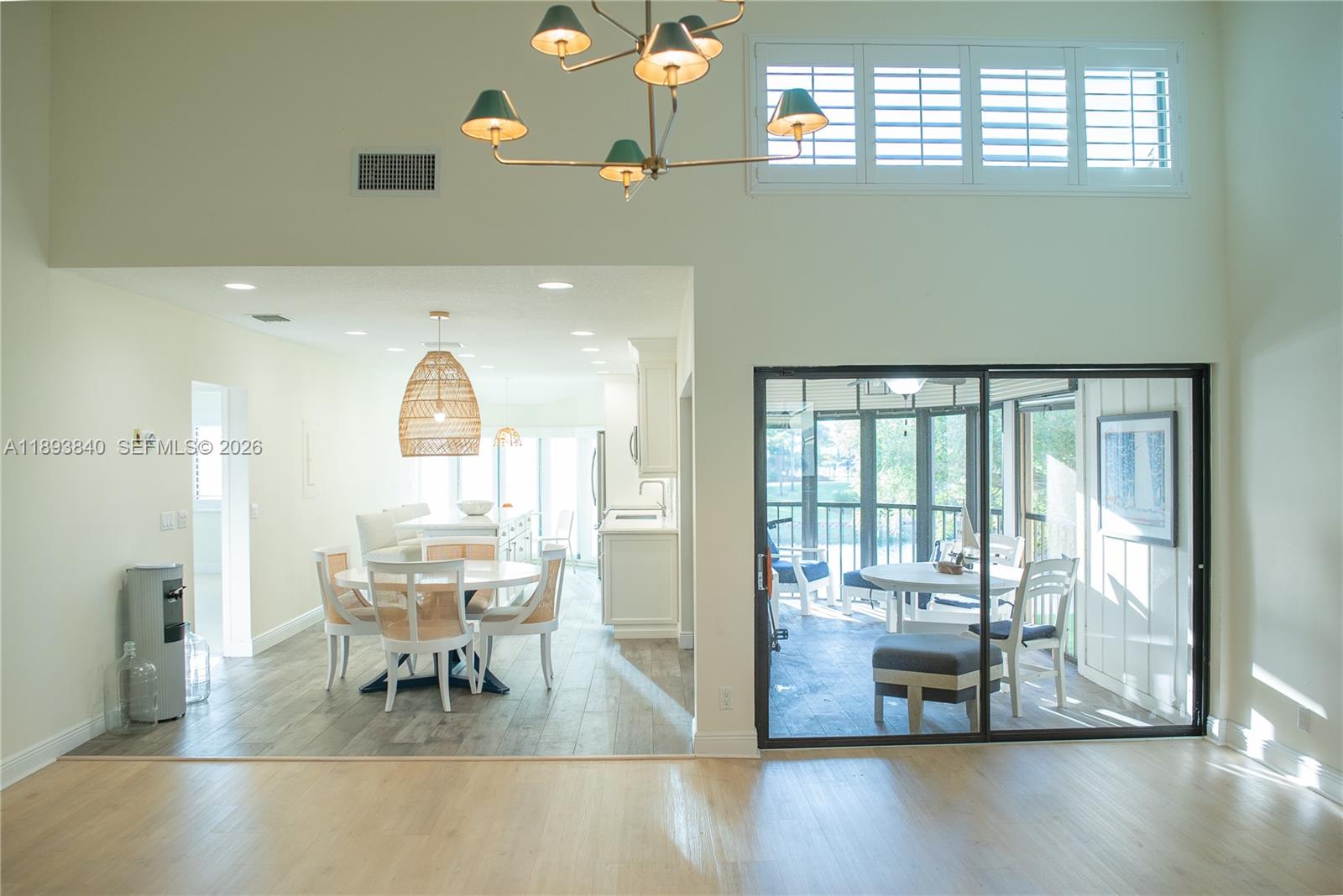 17081 Waterbend Drive, Unit 227 Jupiter, FL 33477 - Photo 10 of 38 a view of dining room and livingroom with furniture wooden floor a chandelier