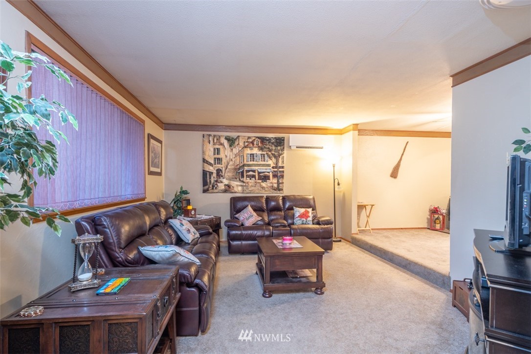 209 Vista Road Chehalis, WA 98532 - Photo 2 of 22 a living room with furniture a flat screen tv and a floor to ceiling window