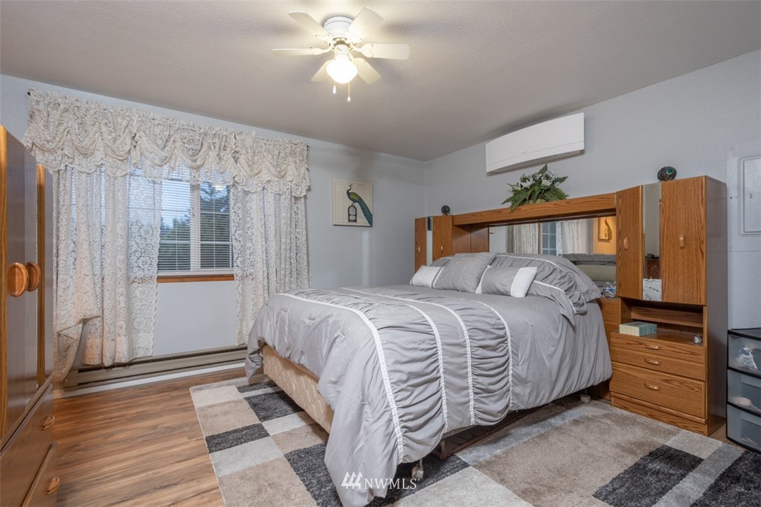209 Vista Road Chehalis, WA 98532 - Photo 8 of 22 a bedroom with a bed and a chandelier