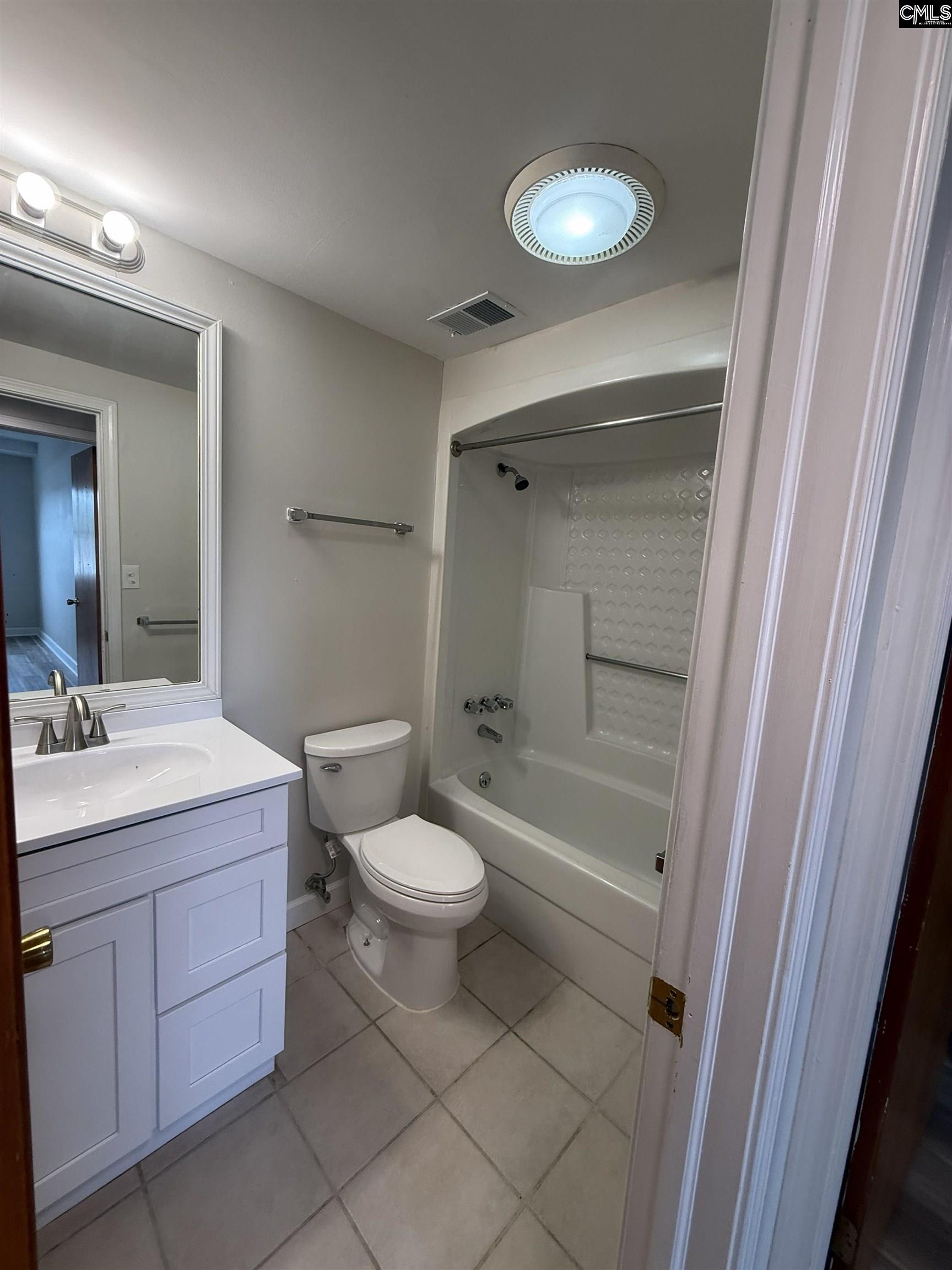 2002 Greene Street, Unit 209 Columbia, SC 29205 - Photo 11 of 22 a bathroom with a toilet sink and a mirror