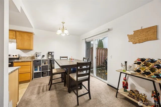 a view of a dining room with furniture and chandelier