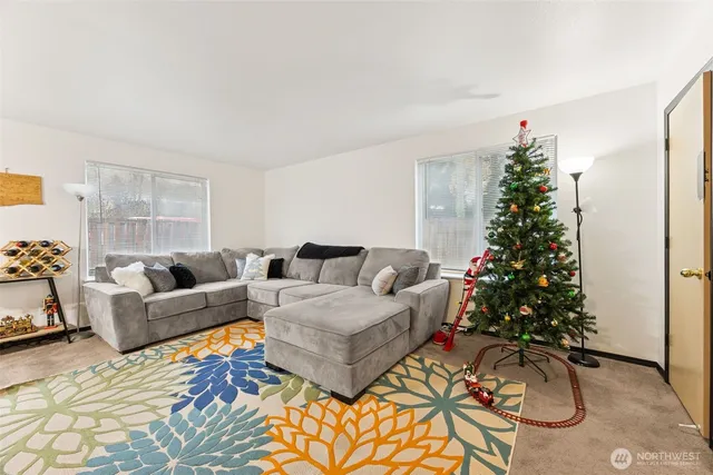 a living room with furniture plant and a window