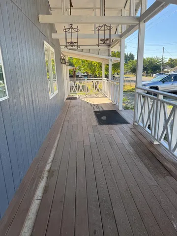 a view of a balcony with wooden floor