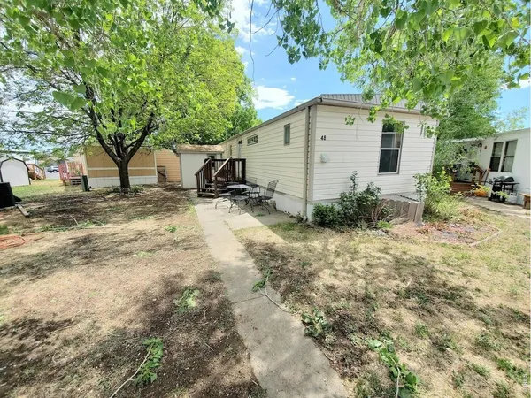 a backyard of a house with table and chairs