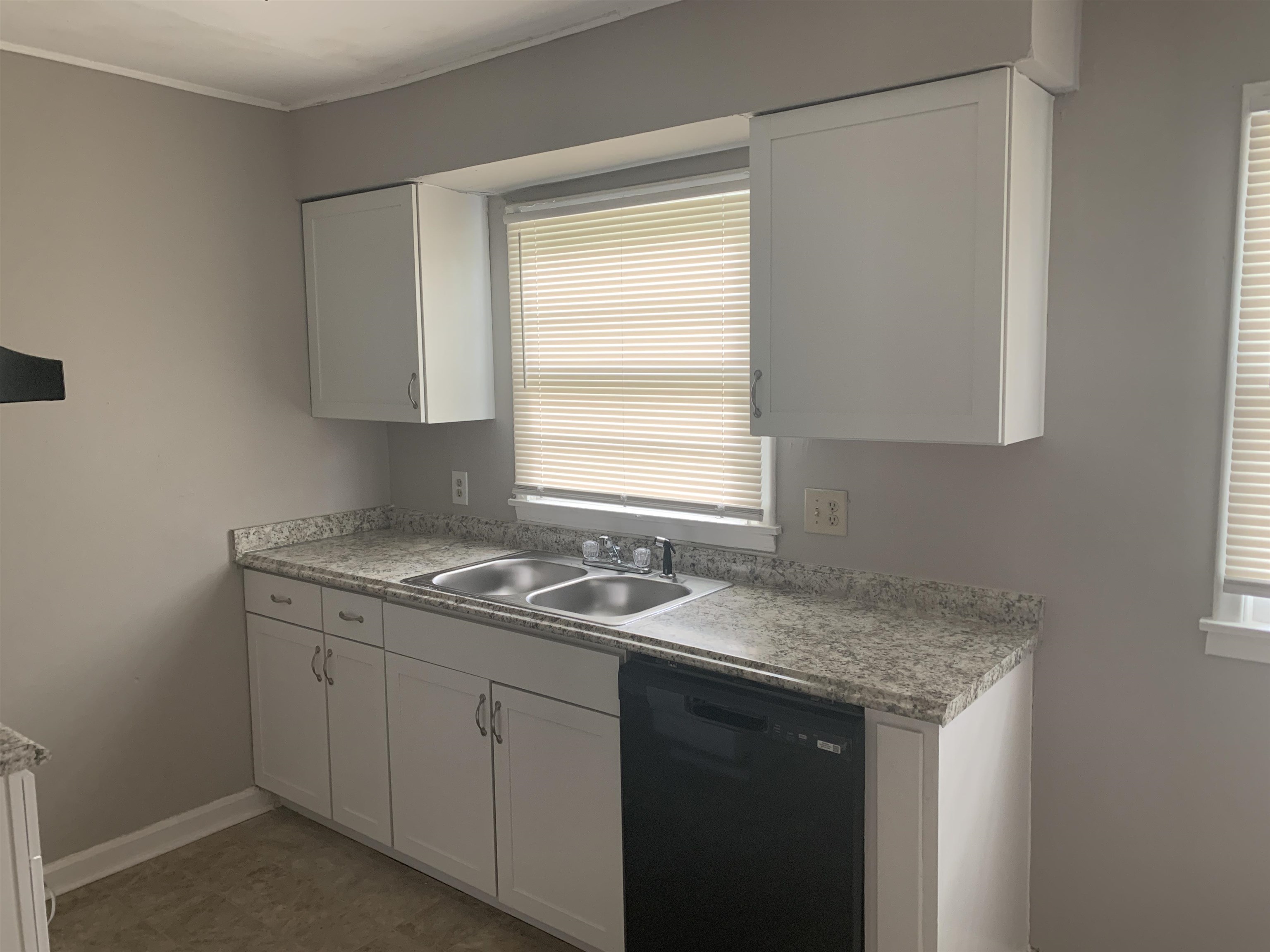 1030 Avon Road Memphis, TN 38122 - Photo 2 of 8 a kitchen with a sink cabinets and window
