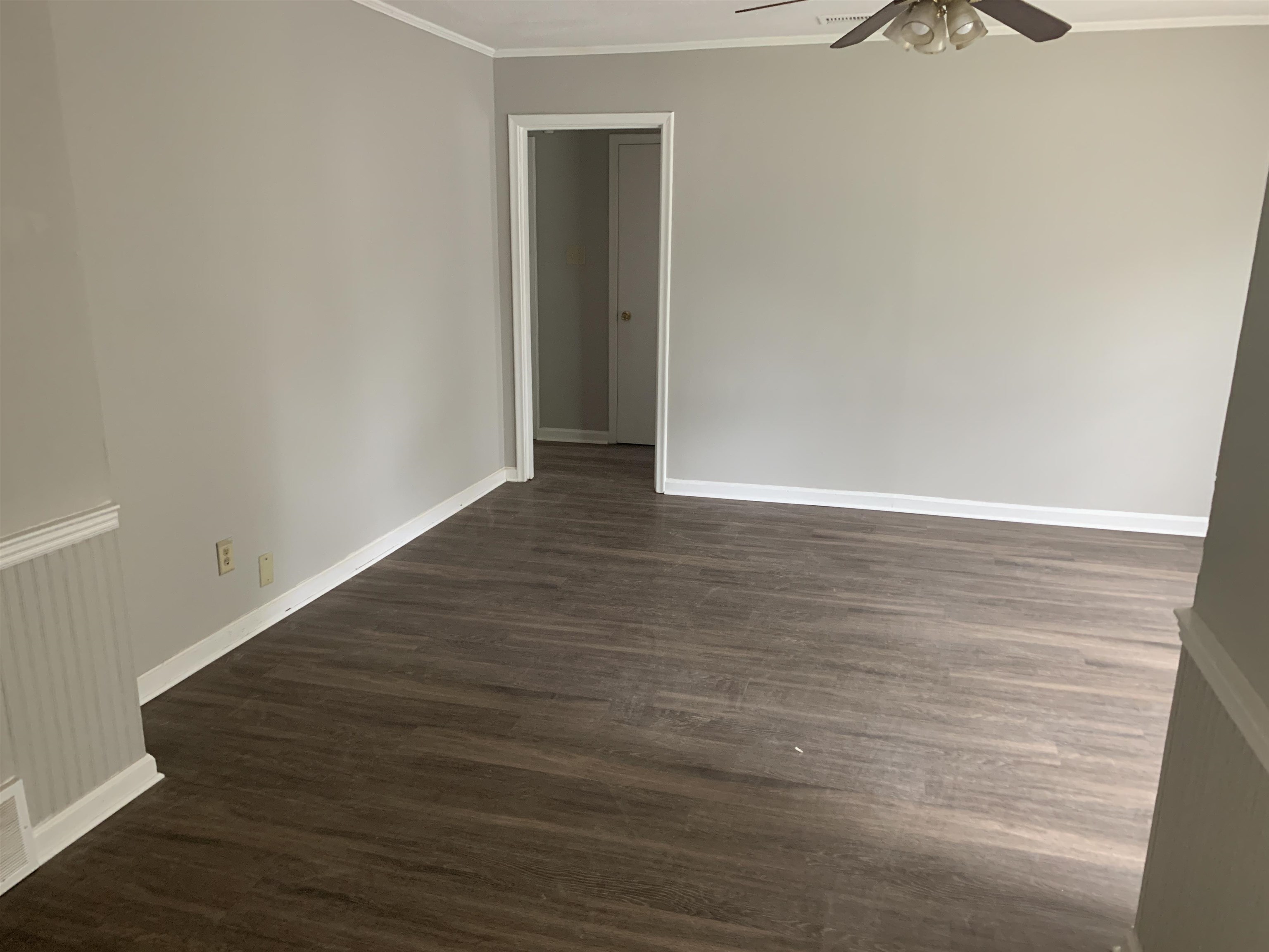 1030 Avon Road Memphis, TN 38122 - Photo 4 of 8 a view of an empty room with wooden floor and a window