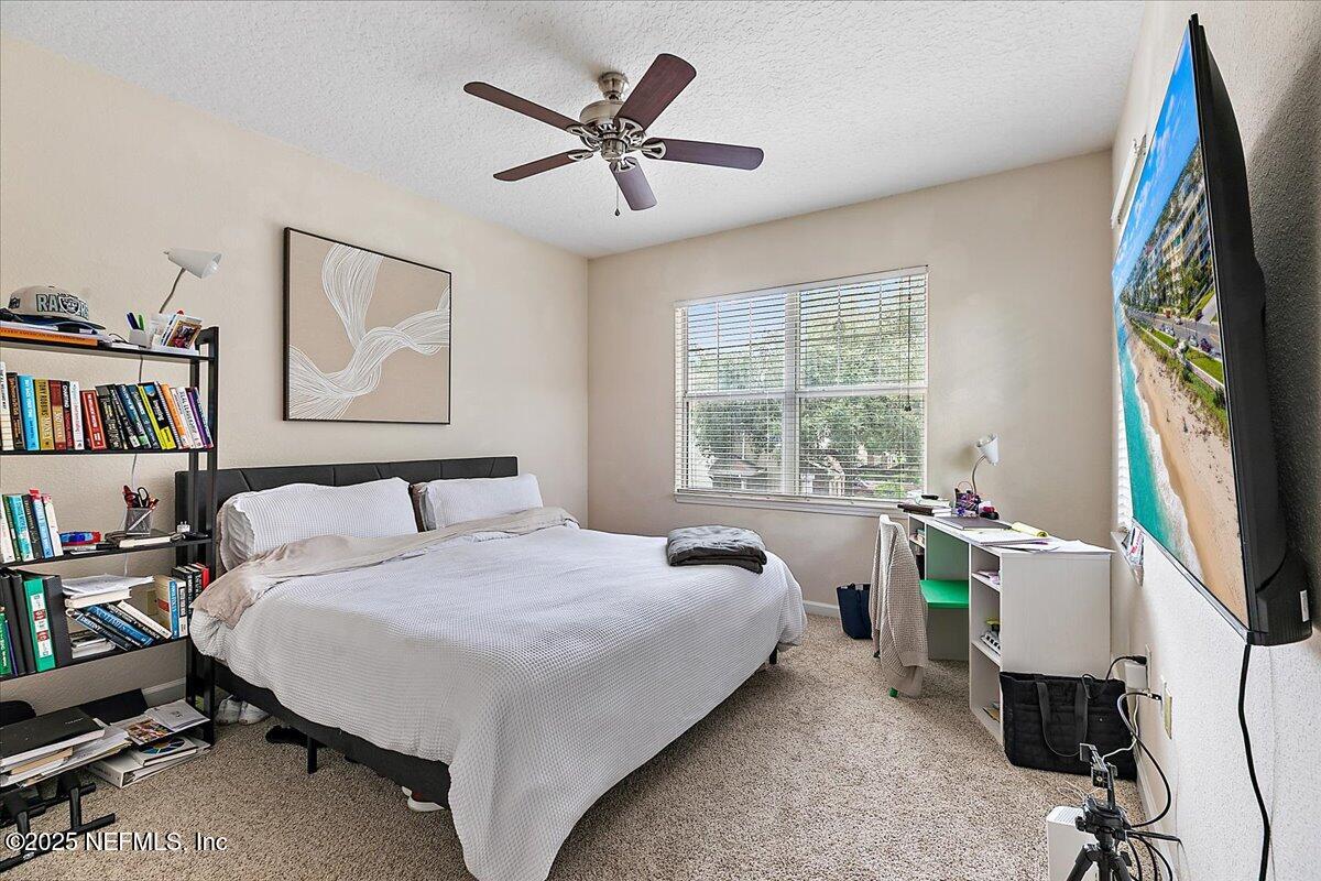 5663 Greenland Road, Unit 1201 Jacksonville, FL 32258 - Photo 11 of 18 a bed room with a bed and a window