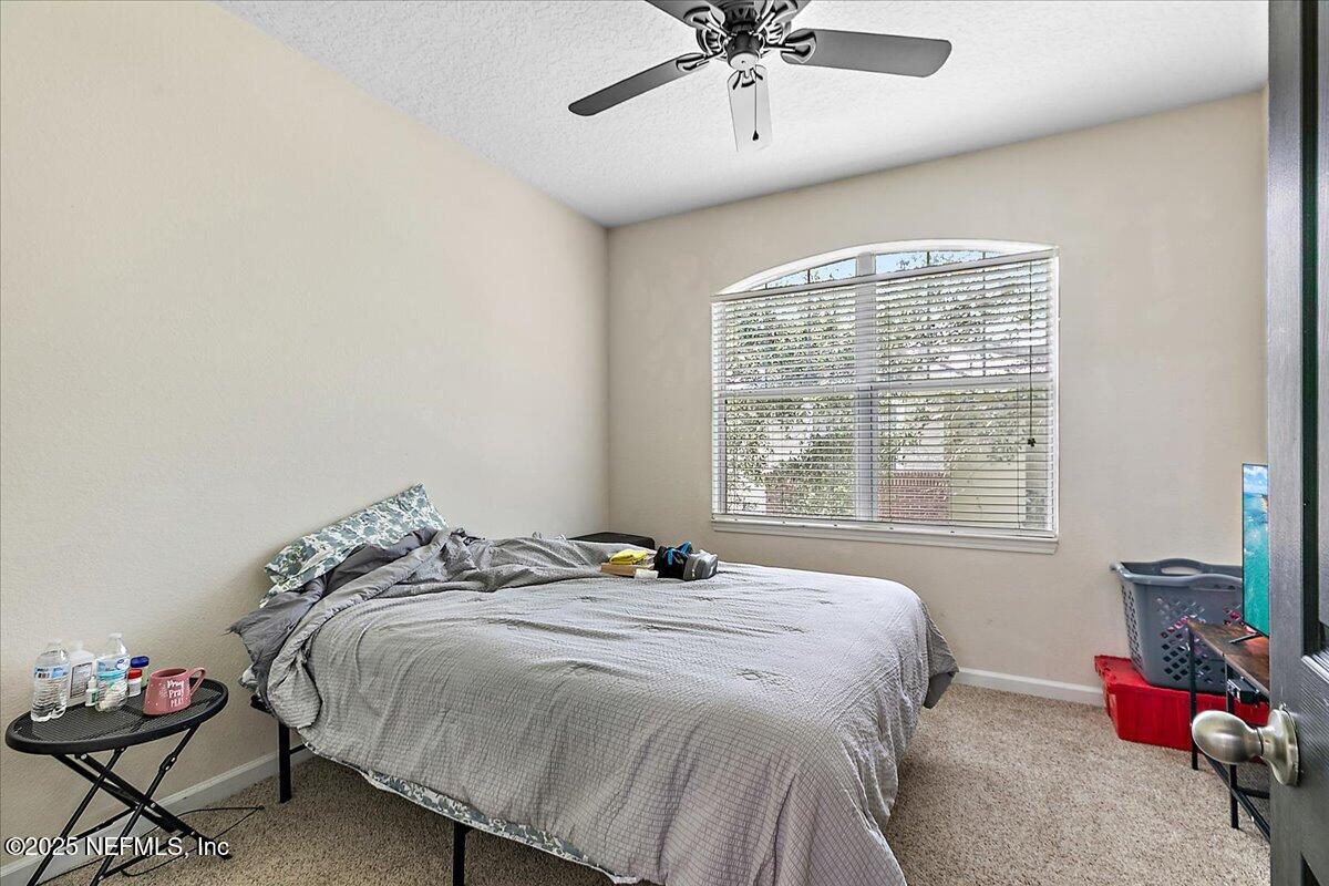 5663 Greenland Road, Unit 1201 Jacksonville, FL 32258 - Photo 14 of 18 a bedroom with a bed and a window