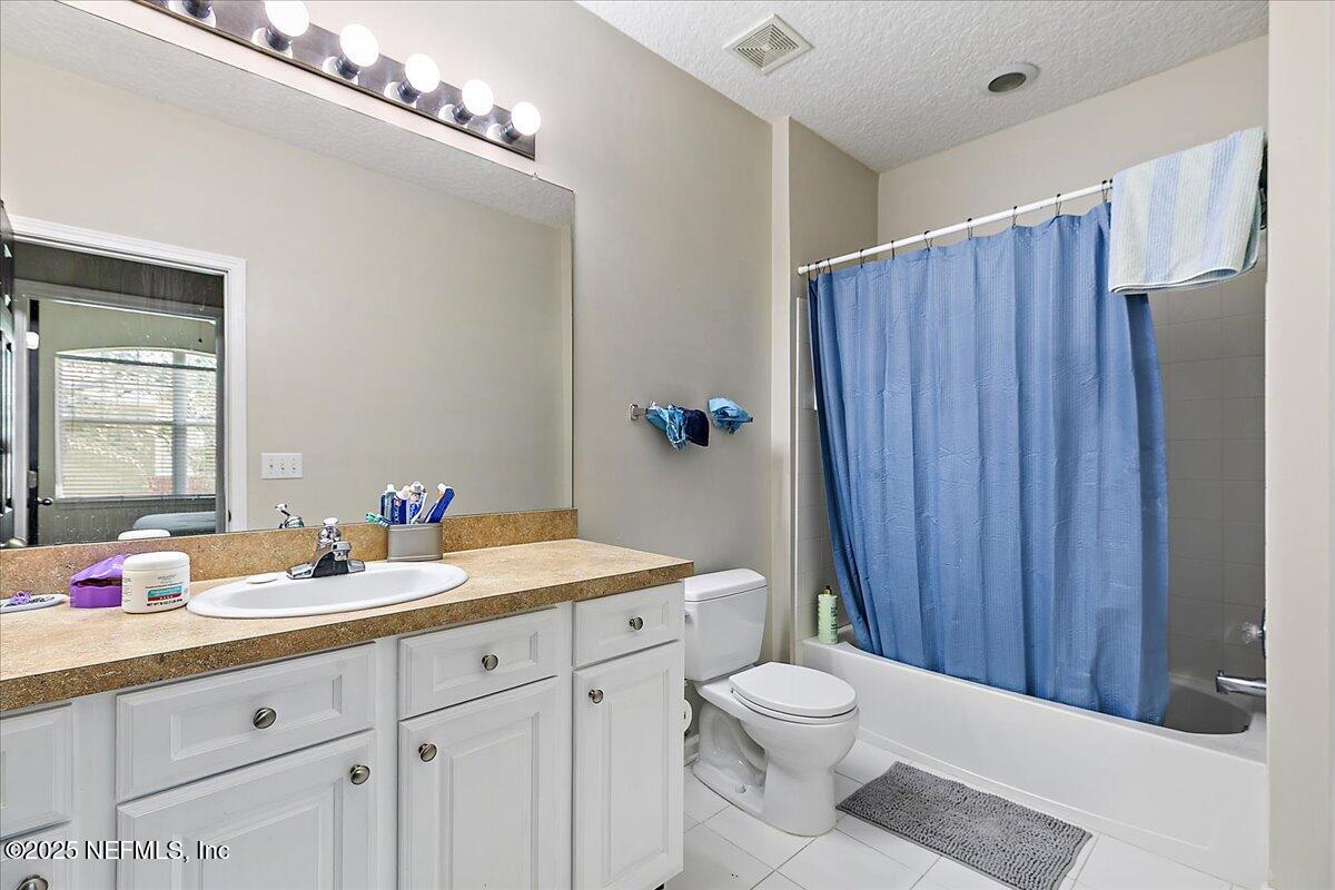 5663 Greenland Road, Unit 1201 Jacksonville, FL 32258 - Photo 15 of 18 a bathroom with a toilet a sink and a mirror