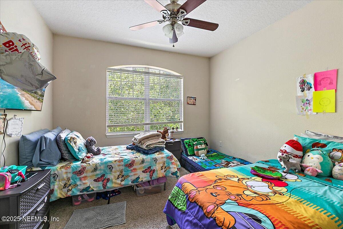 5663 Greenland Road, Unit 1201 Jacksonville, FL 32258 - Photo 16 of 18 a bedroom that has two bed and a window in it