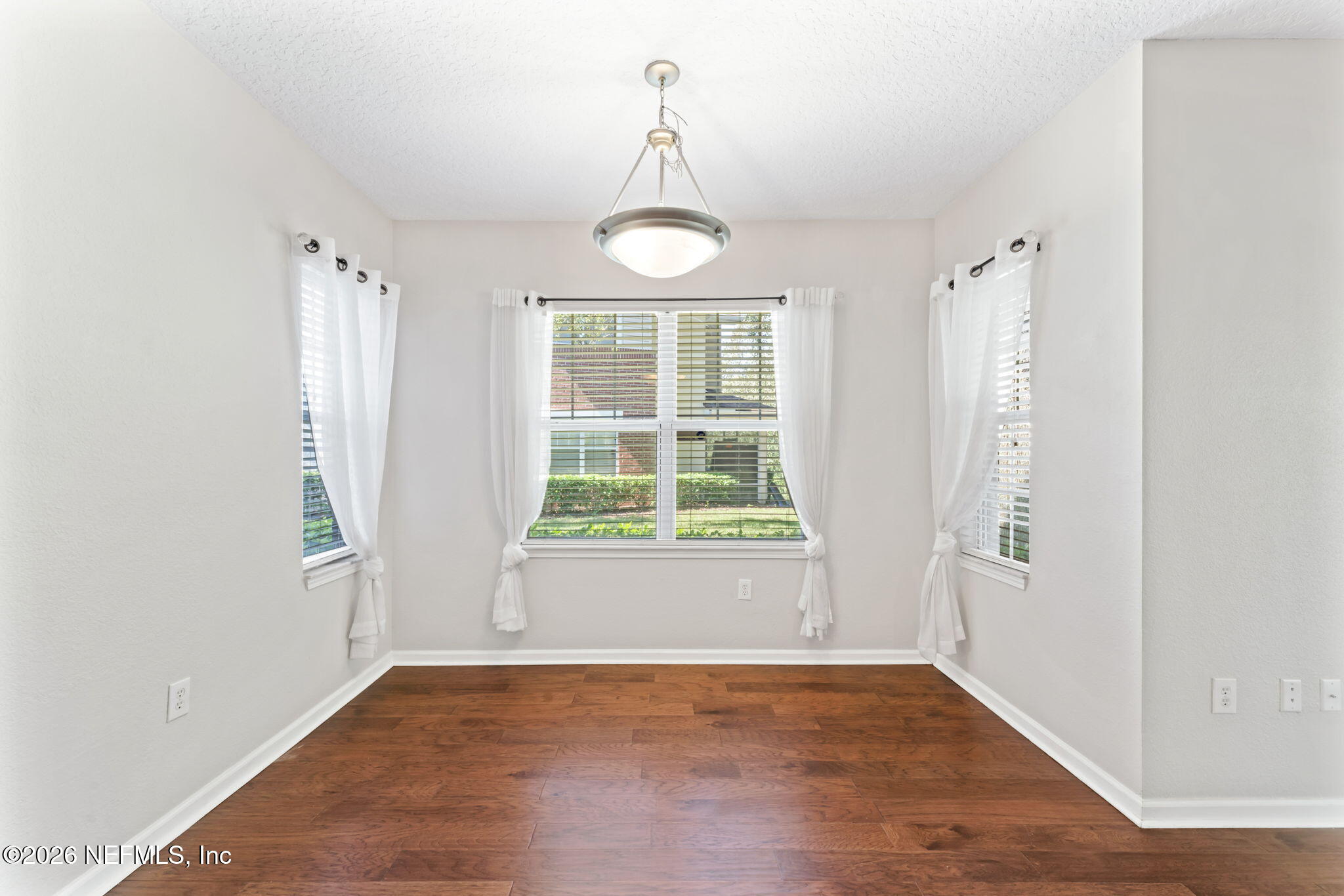 5663 Greenland Road, Unit 1201 Jacksonville, FL 32258 - Photo 19 of 82 a view of an empty room with wooden floor and a window