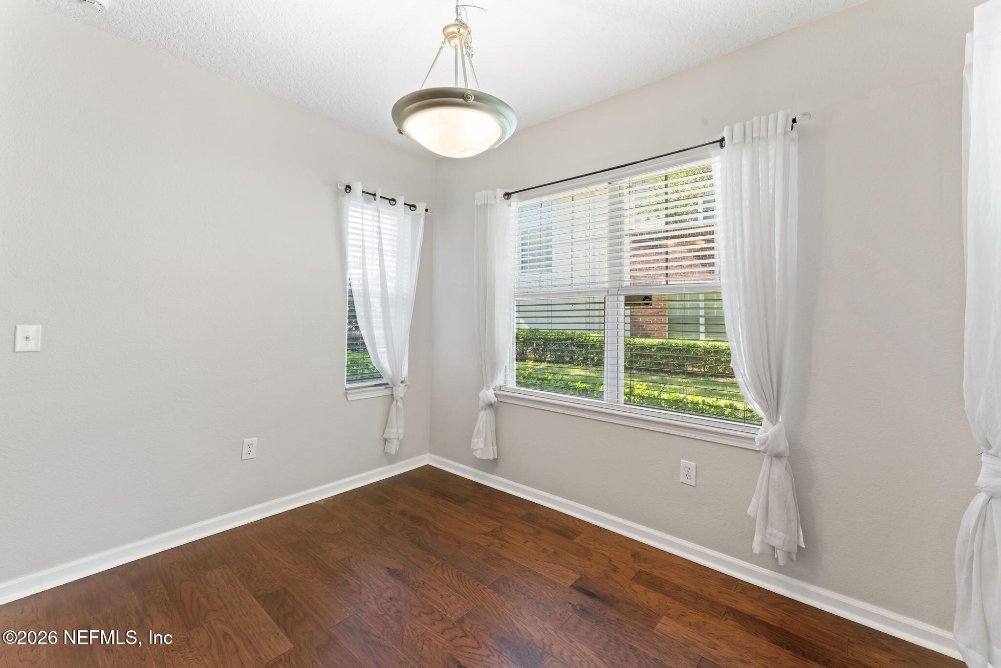 5663 Greenland Road, Unit 1201 Jacksonville, FL 32258 - Photo 20 of 82 a view of an empty room with wooden floor and a window