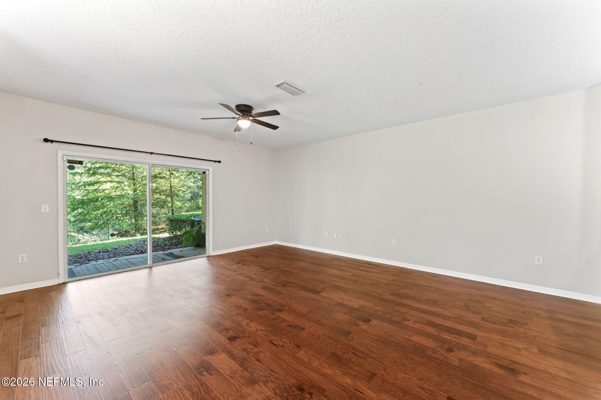 5663 Greenland Road, Unit 1201 Jacksonville, FL 32258 - Photo 22 of 82 a view of an empty room with wooden floor and a window