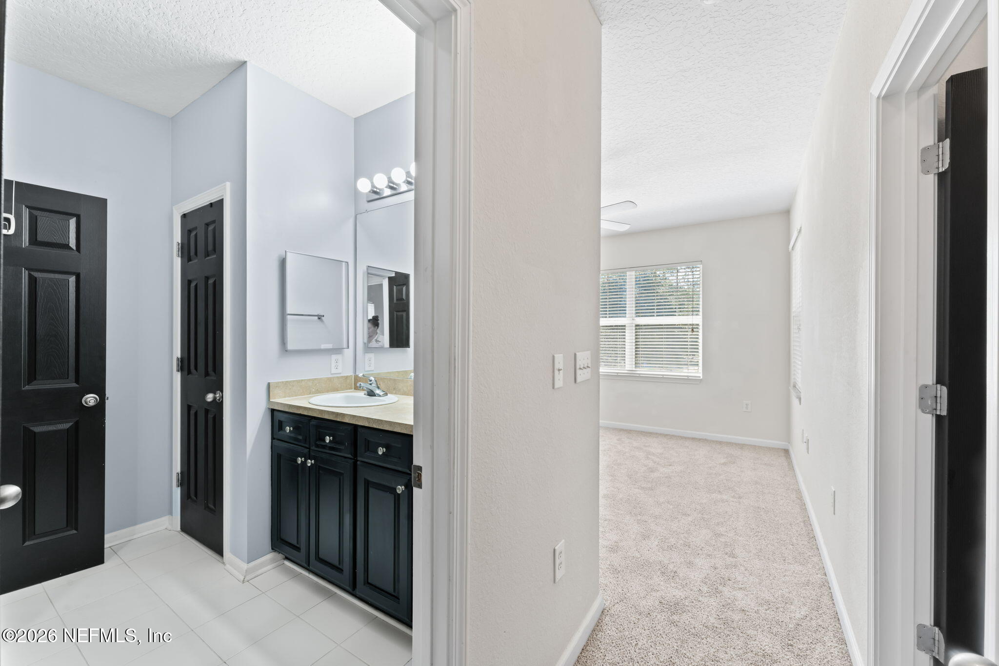5663 Greenland Road, Unit 1201 Jacksonville, FL 32258 - Photo 30 of 82 a bathroom with a double vanity sink and mirror