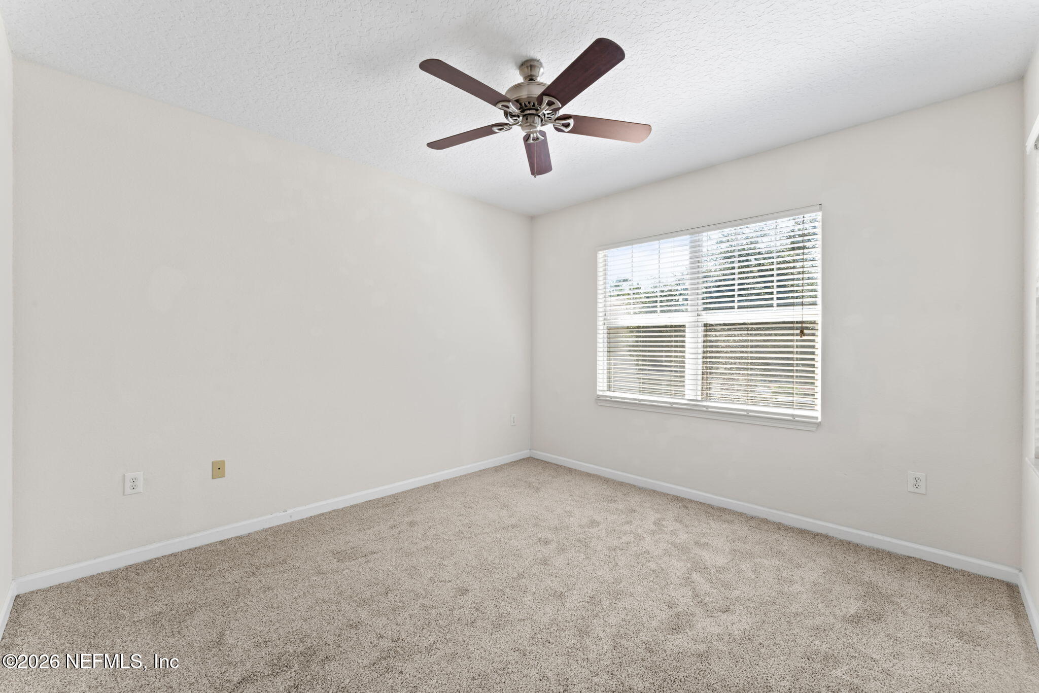 5663 Greenland Road, Unit 1201 Jacksonville, FL 32258 - Photo 31 of 82 an empty room with ceiling fan and window