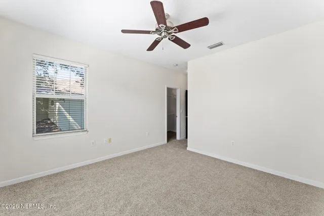 a view of a house with backyard and a large tree