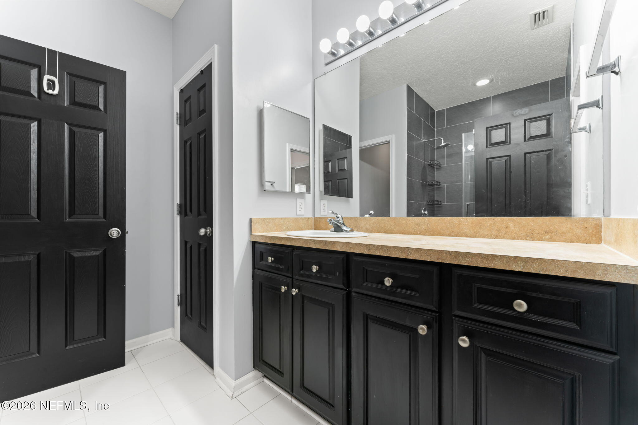 5663 Greenland Road, Unit 1201 Jacksonville, FL 32258 - Photo 36 of 82 a bathroom with a double vanity sink and a mirror