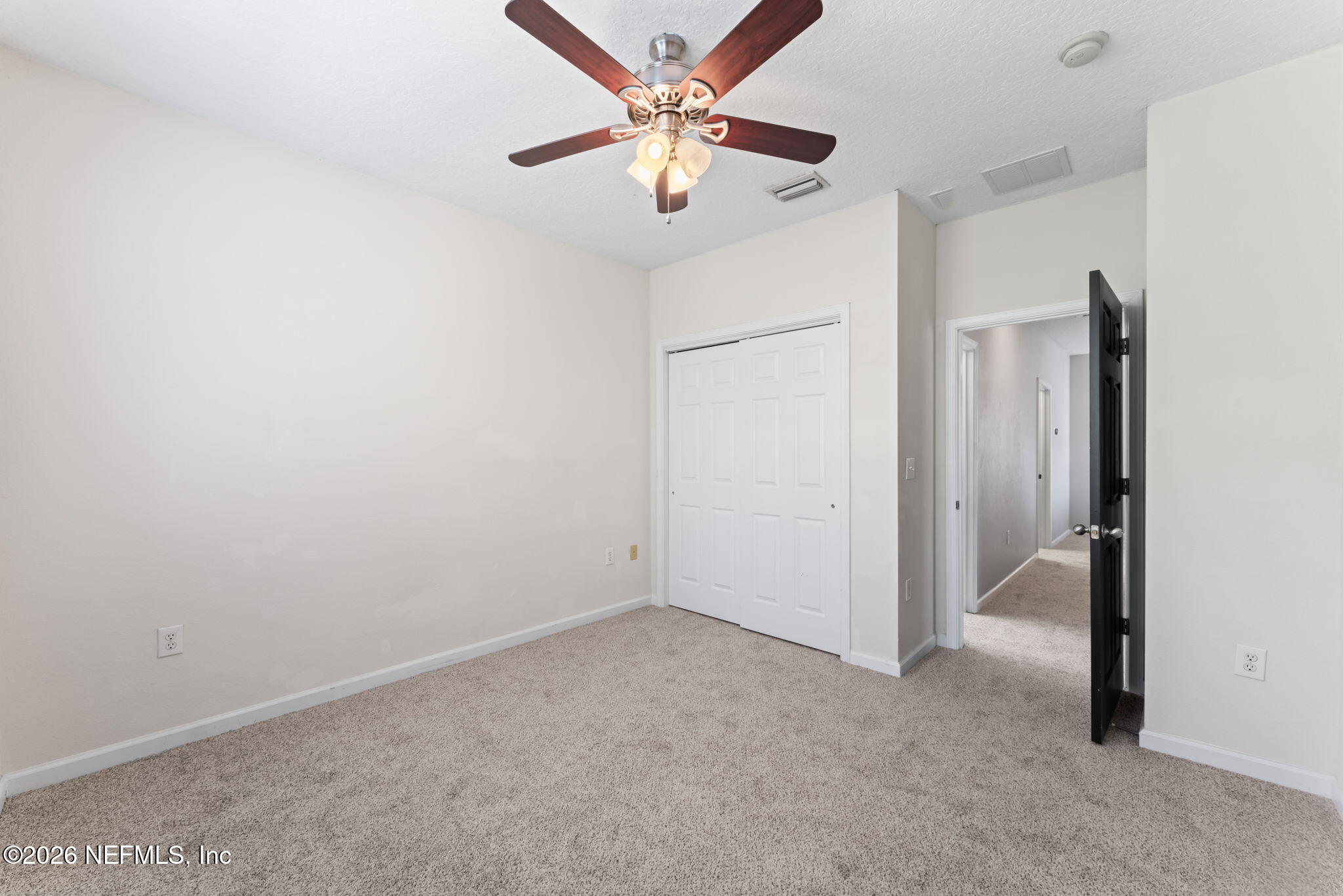 5663 Greenland Road, Unit 1201 Jacksonville, FL 32258 - Photo 40 of 82 an empty room with closet and a ceiling fan