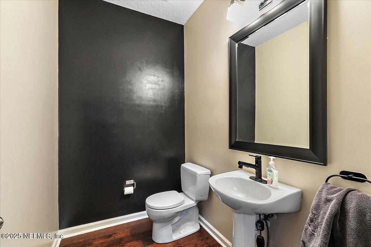 5663 Greenland Road, Unit 1201 Jacksonville, FL 32258 - Photo 4 of 18 a bathroom with a toilet sink and mirror