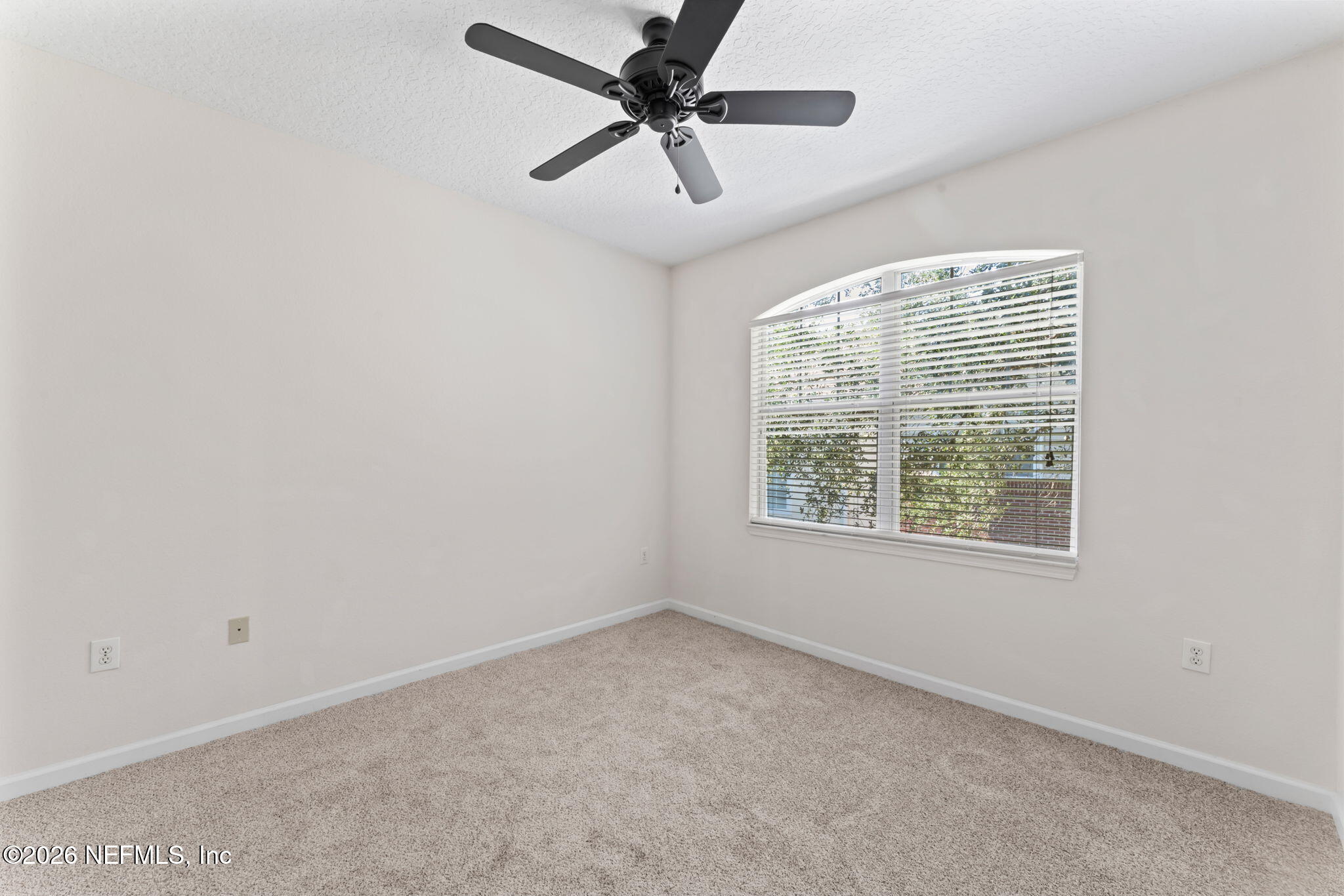 5663 Greenland Road, Unit 1201 Jacksonville, FL 32258 - Photo 43 of 82 an empty room with a window and a fan