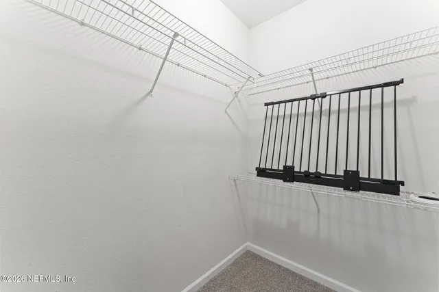 an aerial view of a houses with a yard and lake view