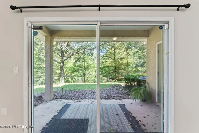 an aerial view of a houses with a yard and lake view