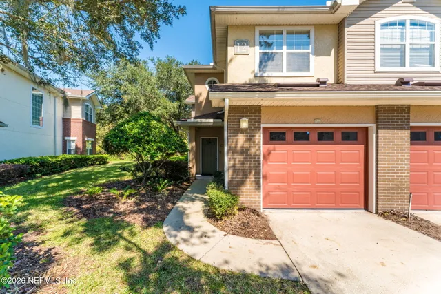 a view of a wooden door and a window