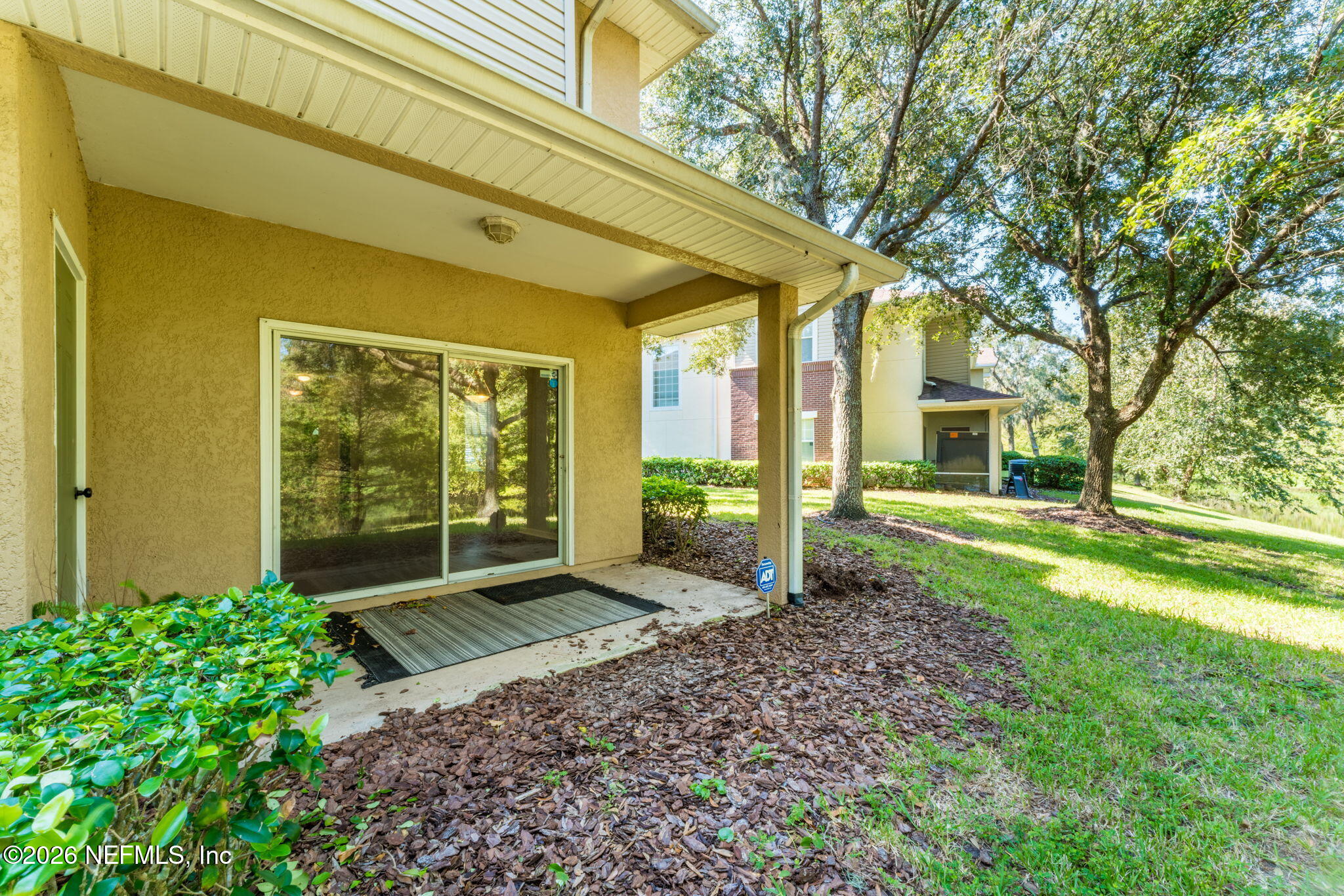 5663 Greenland Road, Unit 1201 Jacksonville, FL 32258 - Photo 55 of 82 a view of a house with backyard and a large tree