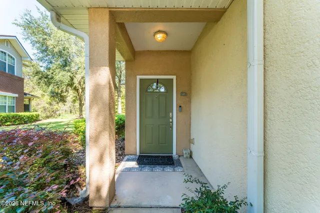a view of a hallway with wooden door