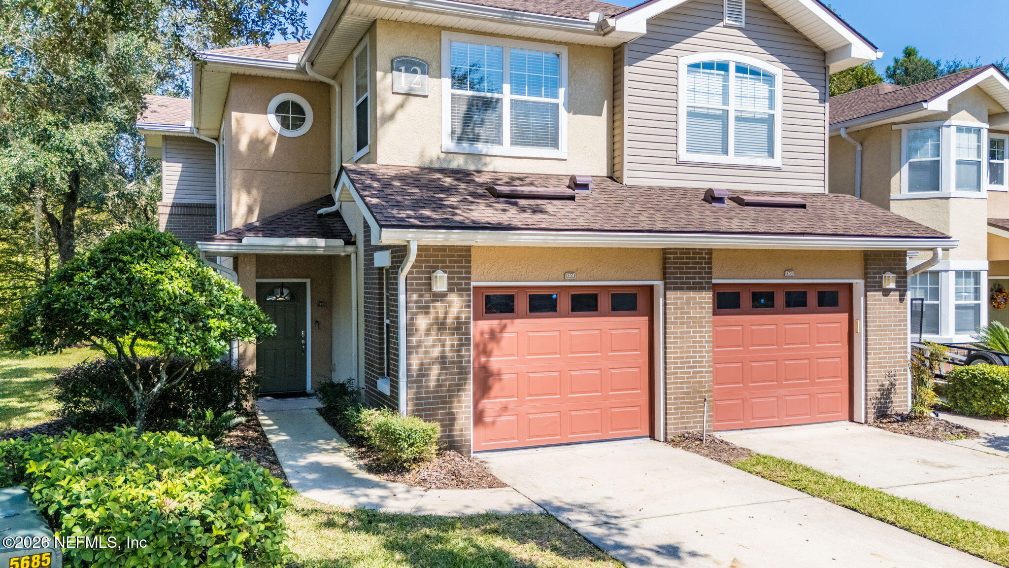 5663 Greenland Road, Unit 1201 Jacksonville, FL 32258 - Photo 68 of 82 a front view of a house with a yard and garage